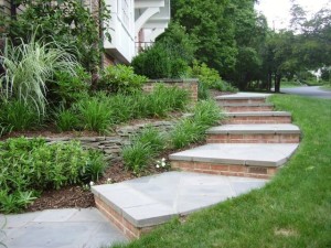 Brick and concrete stairs up to the side of a house